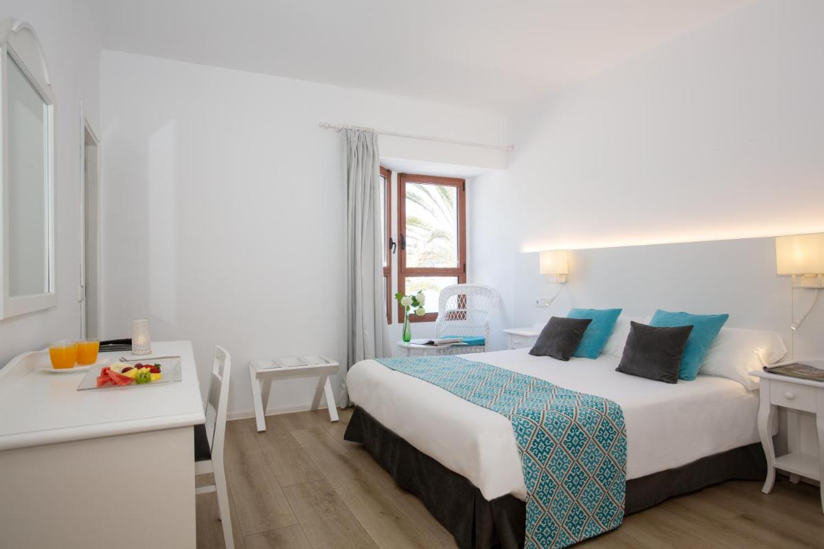 Cama o camas de una habitación en Hotel Marina