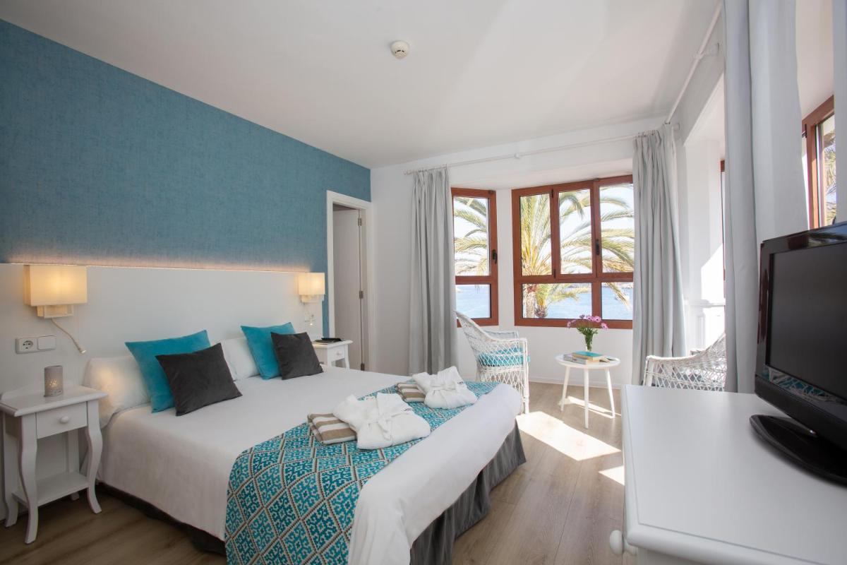 Cama o camas de una habitación en Hotel Marina