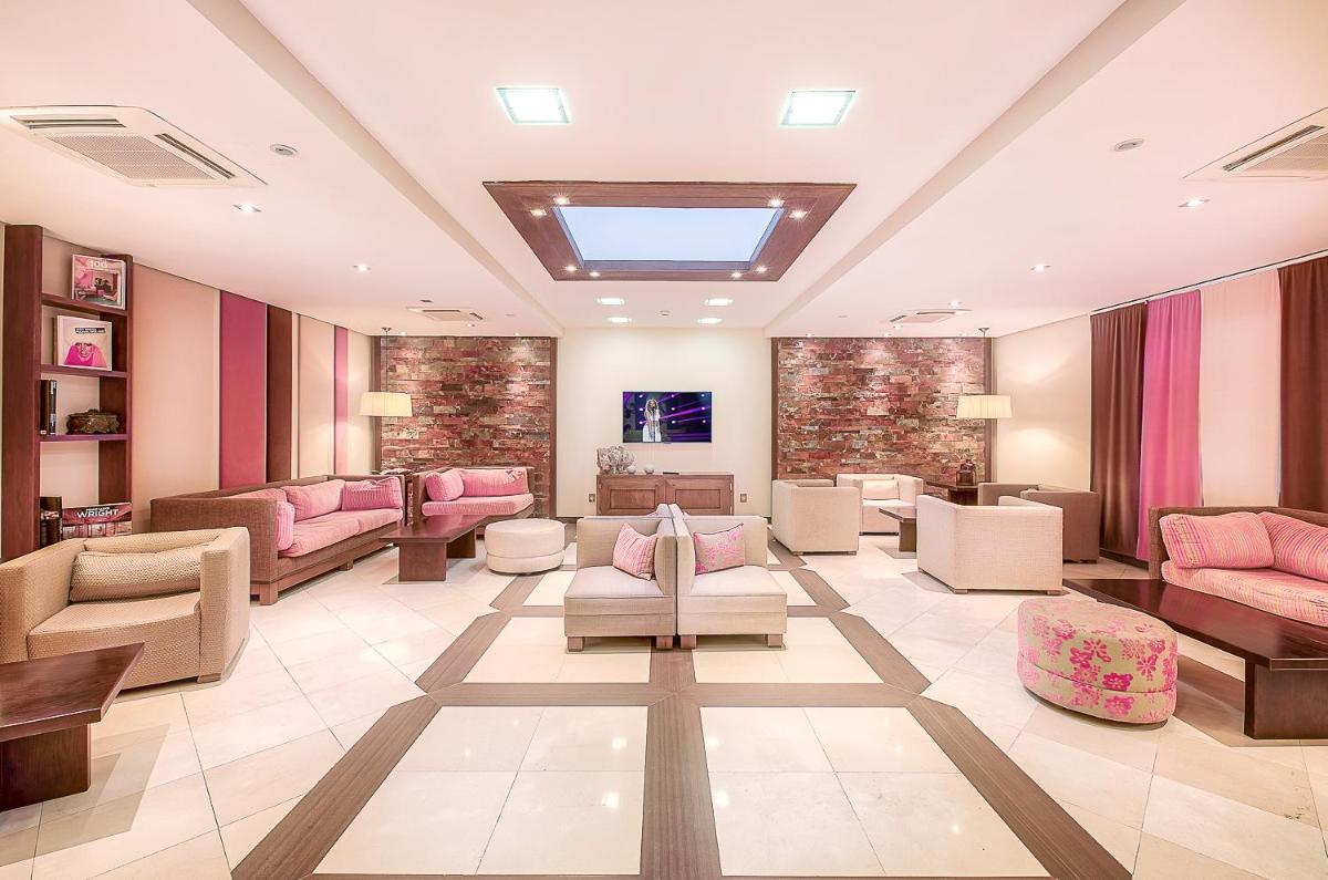 una sala de espera con muebles rosas en un hospital en Hotel LIVVO Volcán Lanzarote, en Playa Blanca