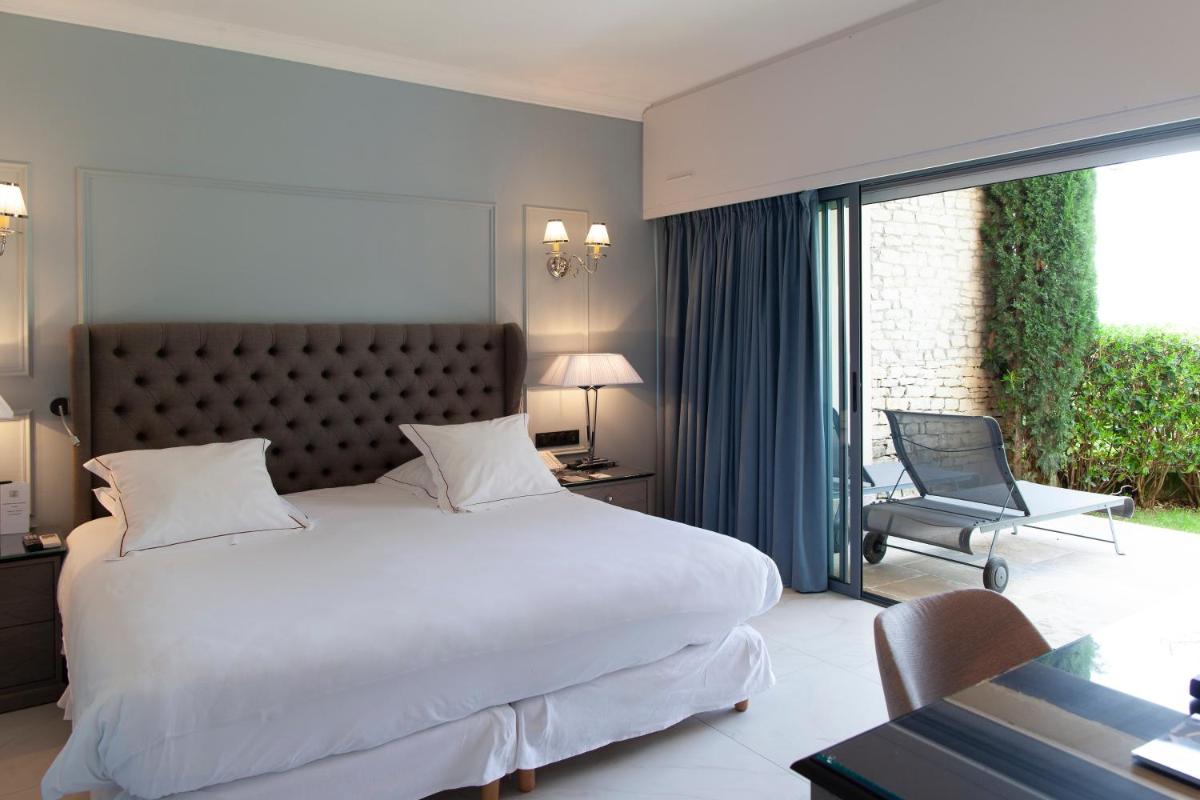 Un ou plusieurs lits dans un hébergement de l'établissement Hotel Les Bories & Spa