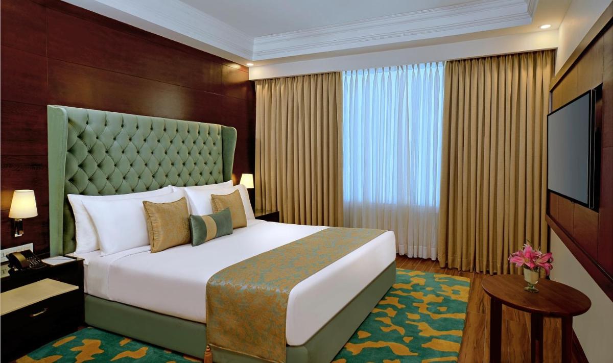 a hotel room with a bed and a television at Radisson Chandigarh Zirakpur in Chandīgarh