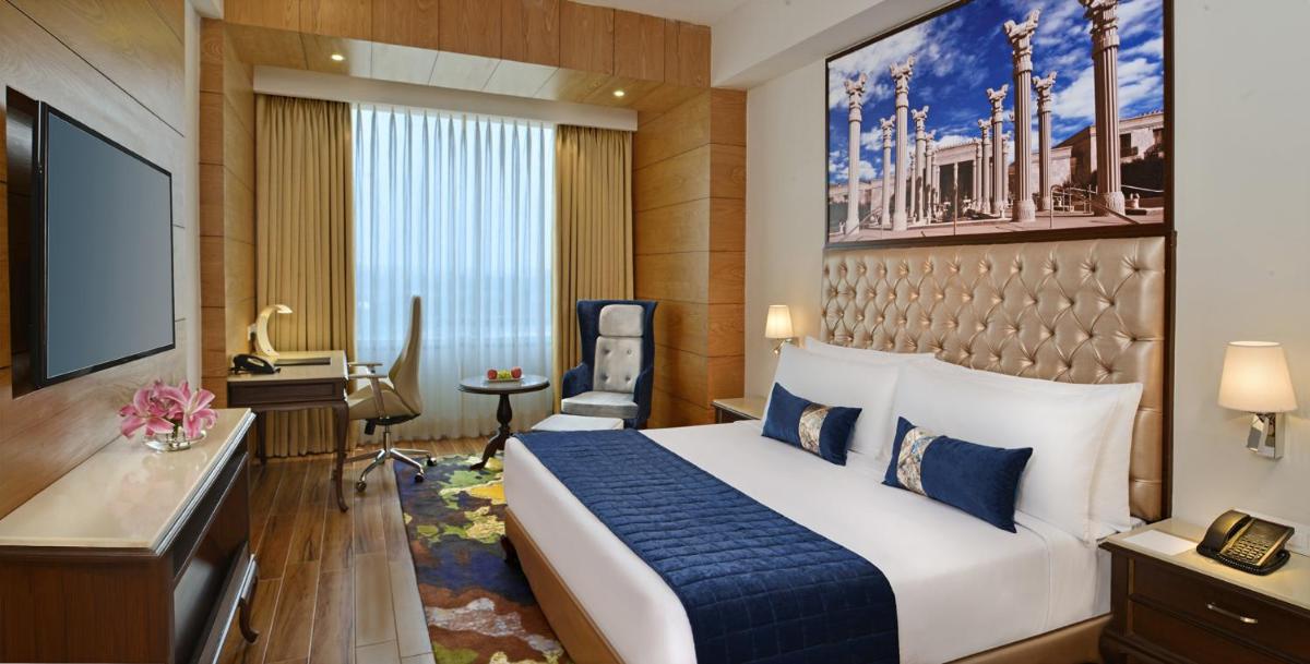 a hotel room with a bed and a television at Radisson Chandigarh Zirakpur in Chandīgarh