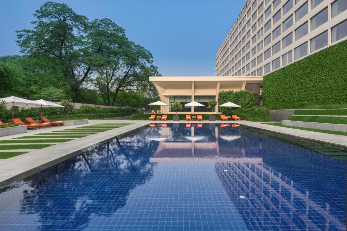 a swimming pool in front of a building at The Oberoi New Delhi in New Delhi a swimming pool in front of a building at The Oberoi New Delhi in New Delhi