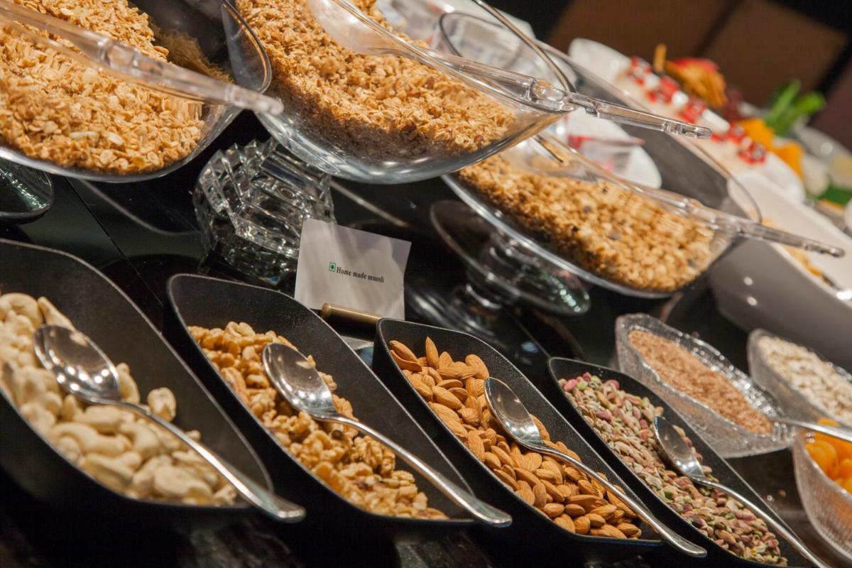 a buffet with many different types of food in spoons at The Oberoi New Delhi in New Delhi a buffet with many different types of food in spoons at The Oberoi New Delhi in New Delhi