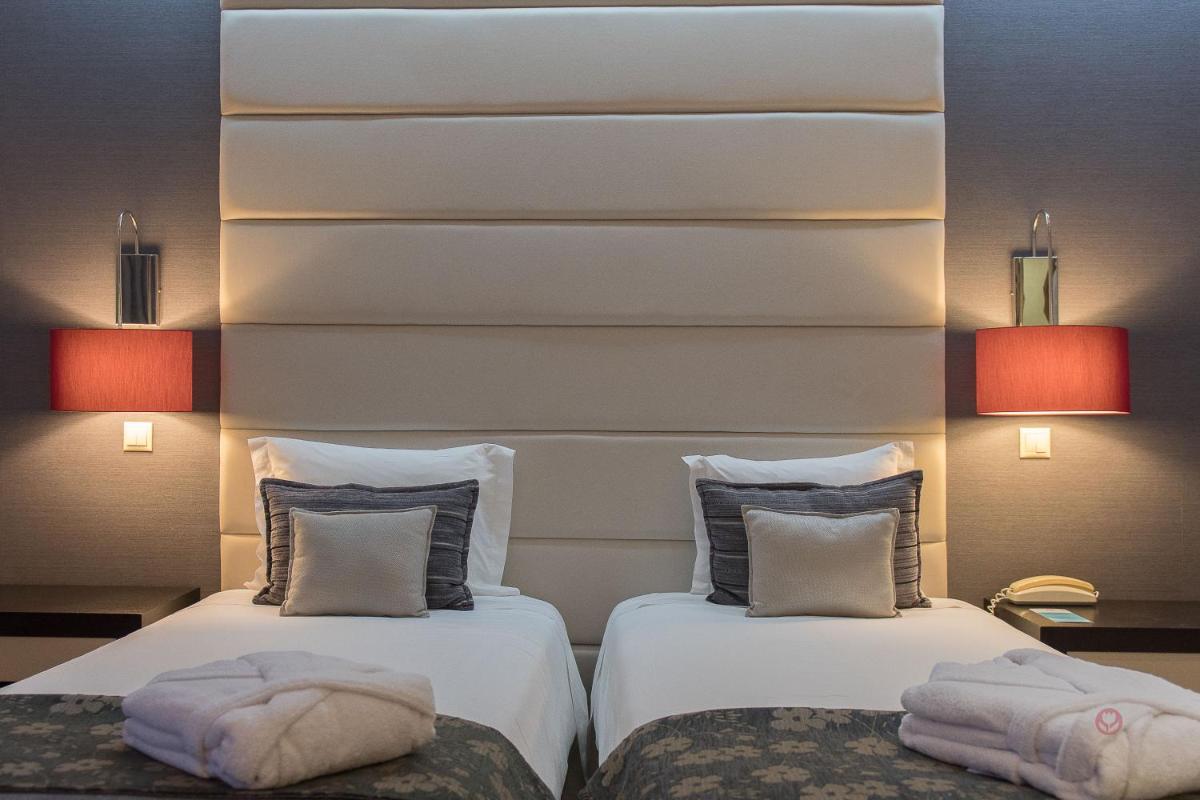 Uma cama ou camas num quarto em Your Hotel & Spa Alcobaça