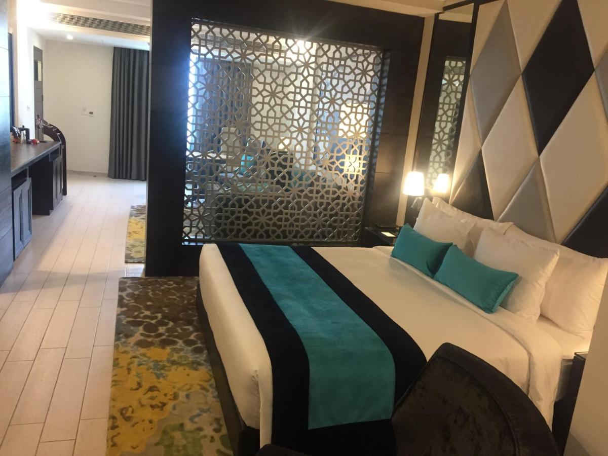 a bedroom with a large bed in a hotel room at Radisson Chandigarh Zirakpur in Chandīgarh