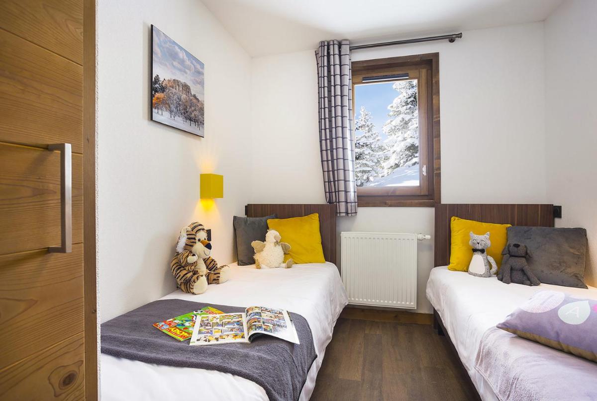 Un ou plusieurs lits dans un hébergement de l'établissement Résidence Club MMV Les Chalets des Cimes