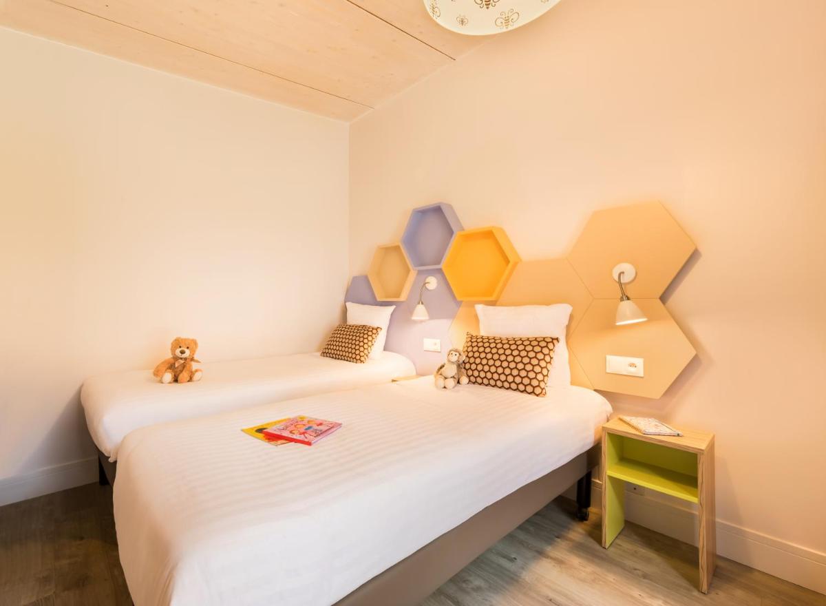Cama o camas de una habitación en Center Parcs Villages Nature Paris