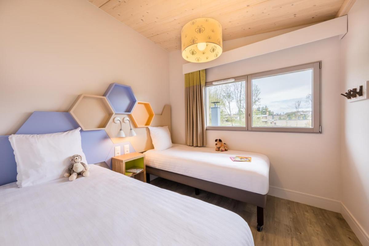 Cama o camas de una habitación en Center Parcs Villages Nature Paris