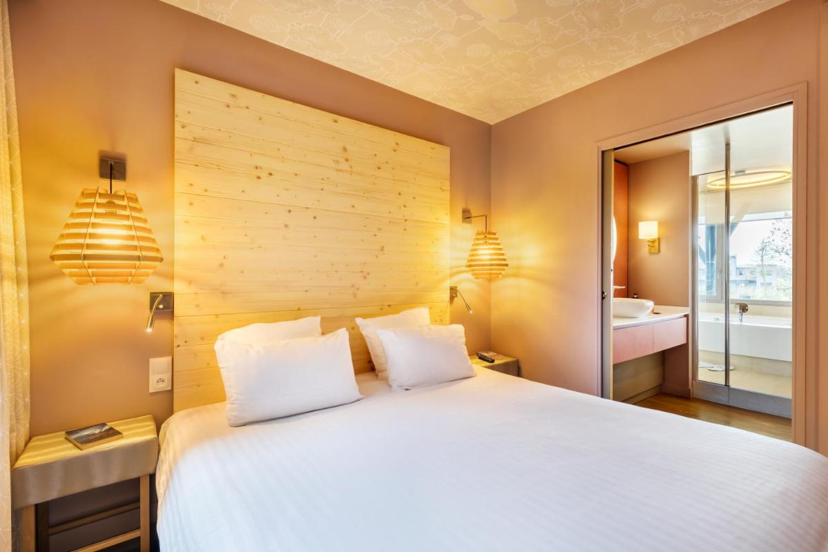 Cama o camas de una habitación en Center Parcs Villages Nature Paris