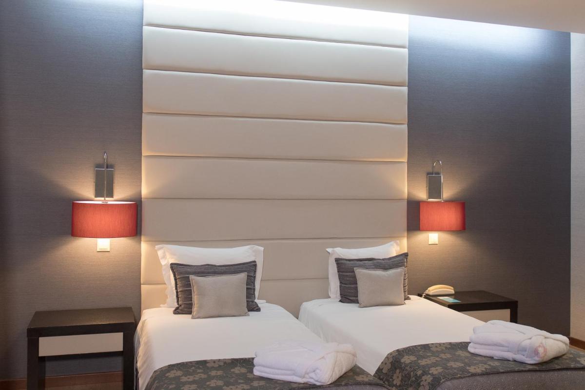 Uma cama ou camas num quarto em Your Hotel & Spa Alcobaça