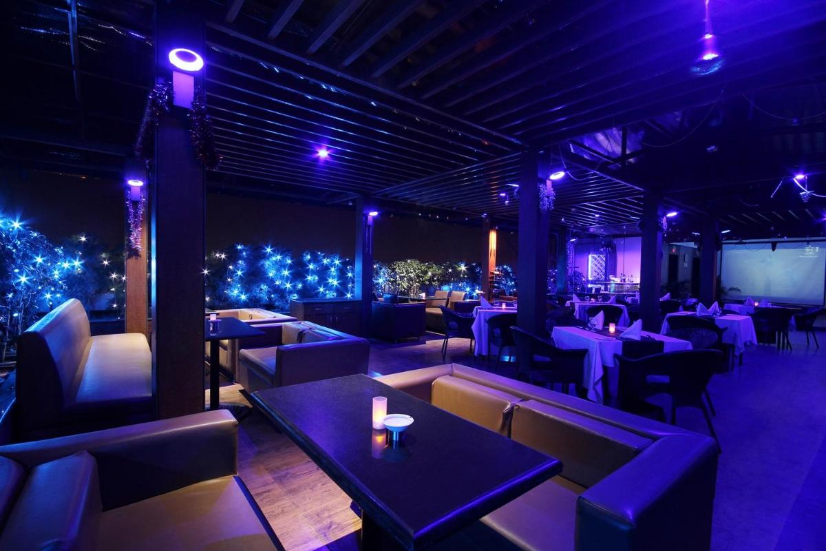 a restaurant with tables and chairs and christmas lights at Fortune Select JP Cosmos, Bengaluru - Member ITC Hotels' Group in Bengaluru