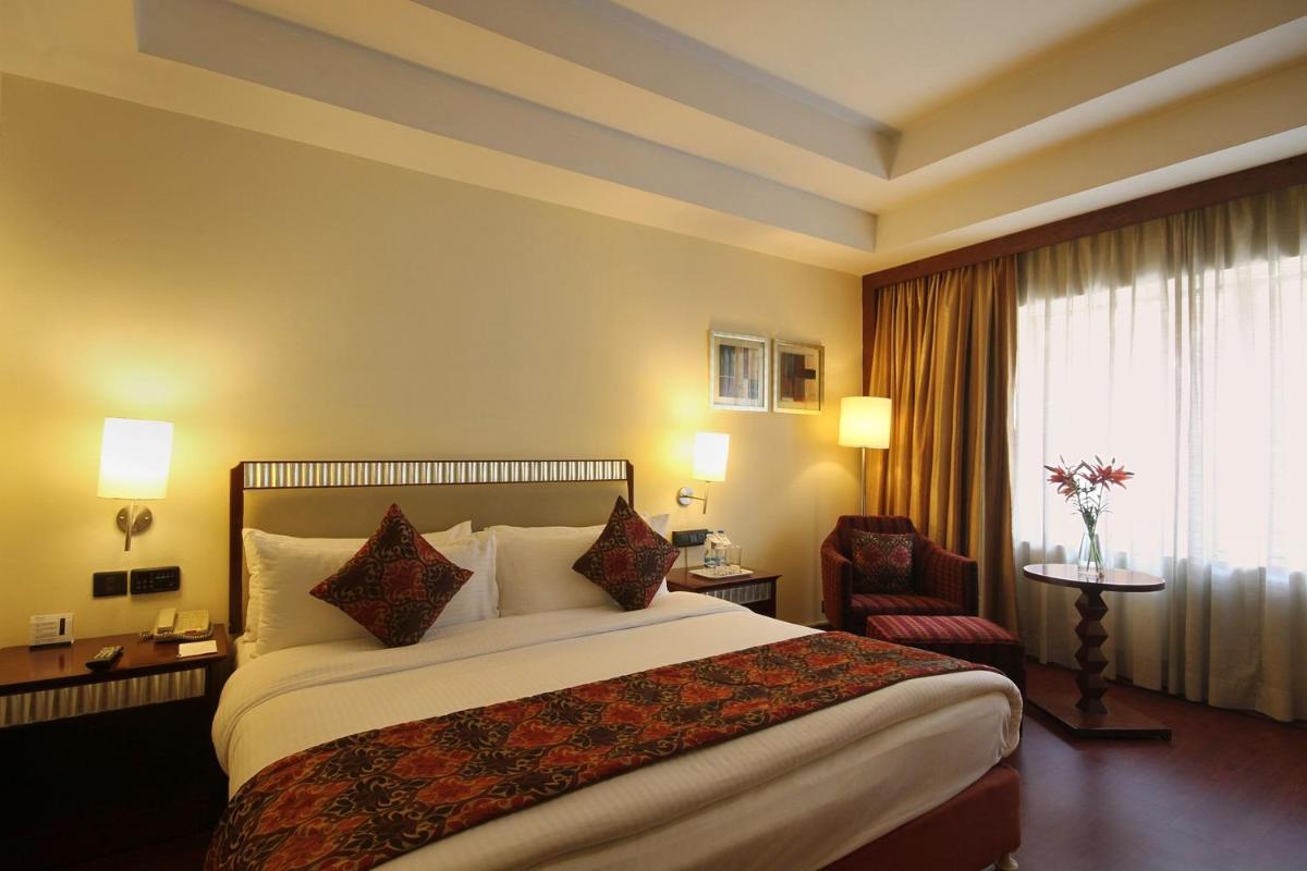 a hotel room with a bed and a window at Fortune Select JP Cosmos, Bengaluru - Member ITC Hotels' Group in Bengaluru