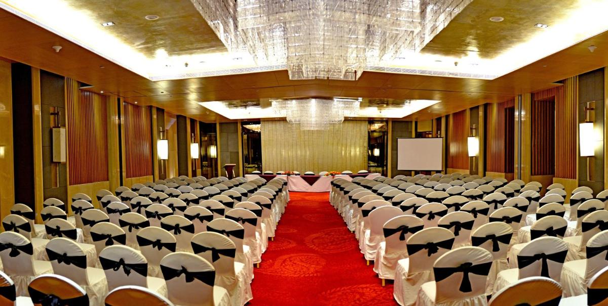 a large room with rows of chairs with umbrellas at Radisson Blu Jaipur in Jaipur