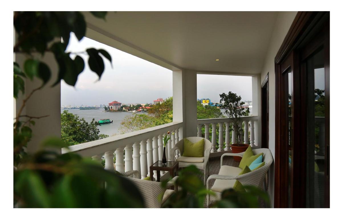 a balcony with a view of the water at Fragrant Nature Kochi - A Five star Classified Hotel in Cochin