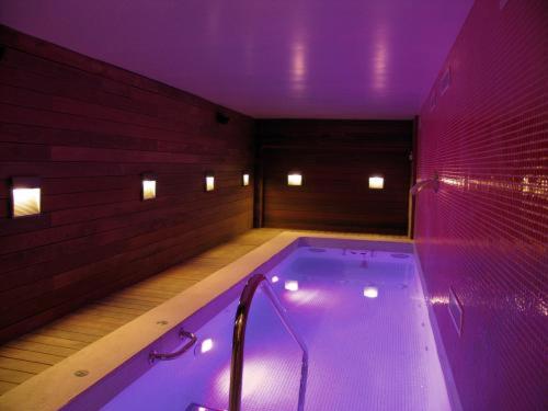 Habitación con bañera grande con iluminación púrpura. en San Ramón del Somontano, en Barbastro