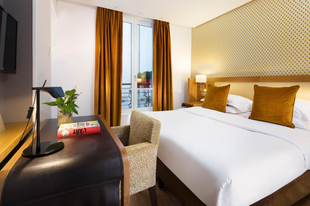 Un ou plusieurs lits dans un hébergement de l'établissement Hotel Le Six