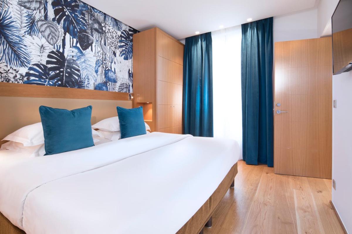 Un ou plusieurs lits dans un hébergement de l'établissement Hotel Le Six