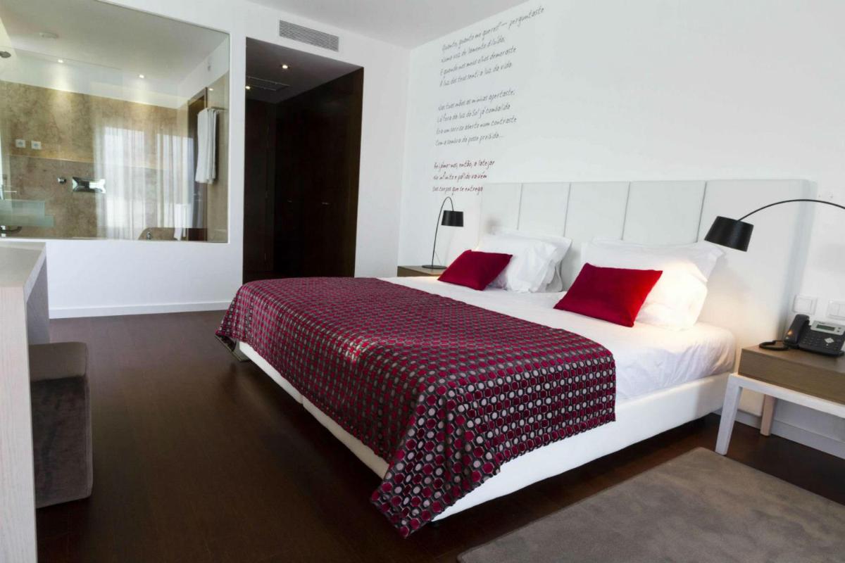 Uma cama ou camas num quarto em Hotel Vila D'Óbidos