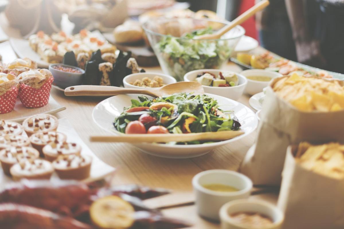 a table with plates of food and other foods at The Oterra in Bengaluru
