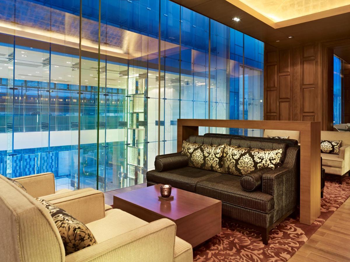 a living room with a couch and a table at Taj City Centre Gurugram in Gurgaon