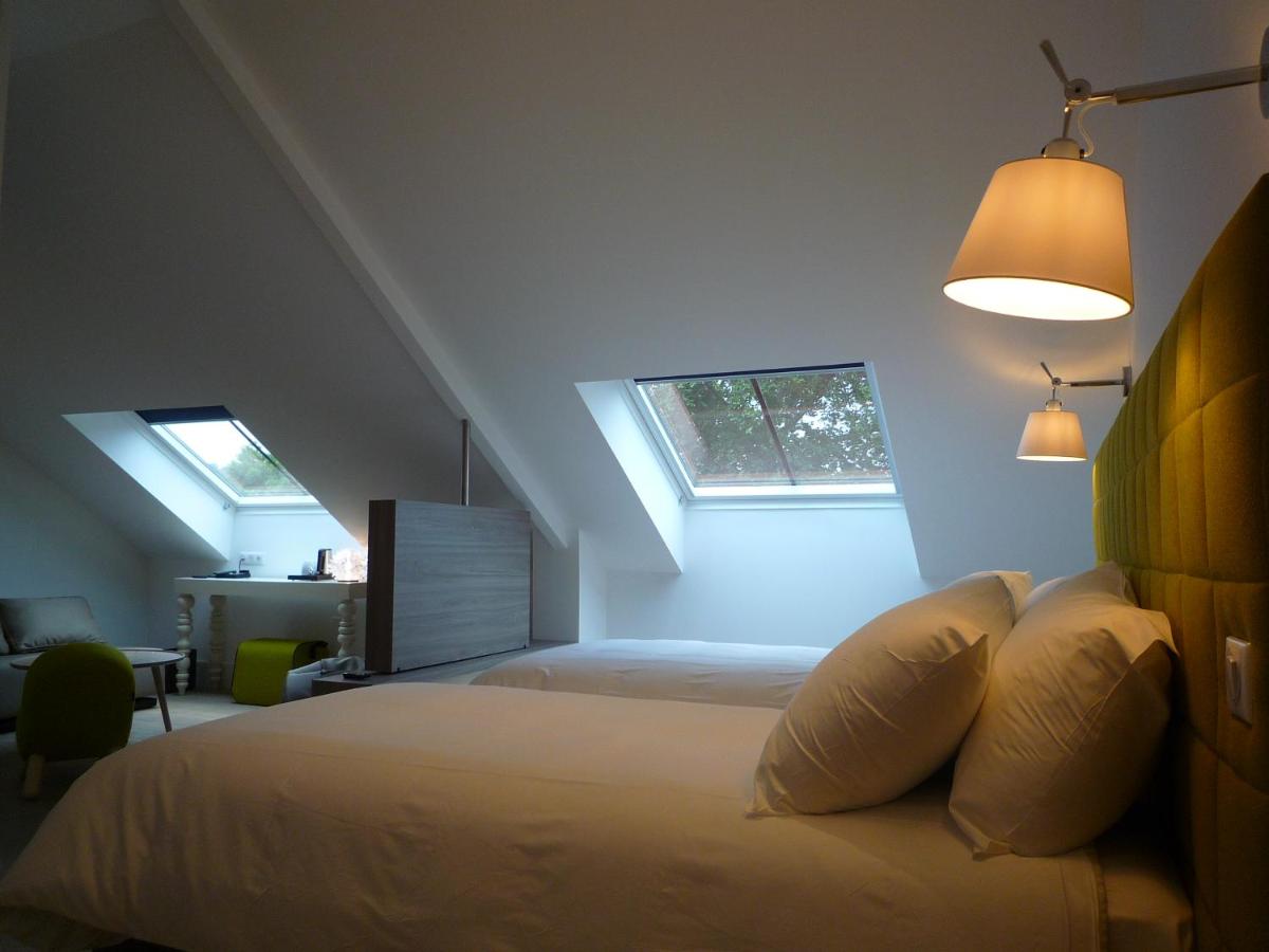 Un ou plusieurs lits dans un hébergement de l'établissement Hôtel Ginkgo - SPA Biloba