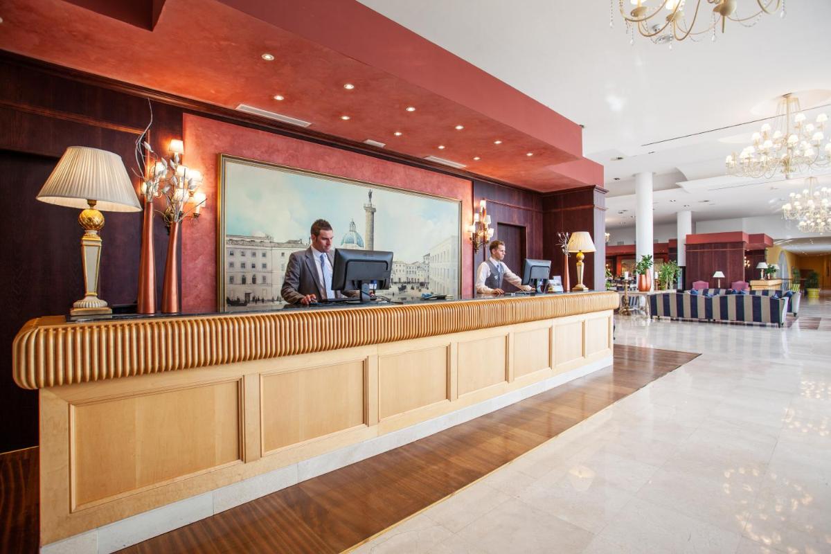 un bar en un hotel con dos hombres parados en un mostrador en Grupotel Playa de Palma Suites & Spa, en Playa de Palma 80 fotos más