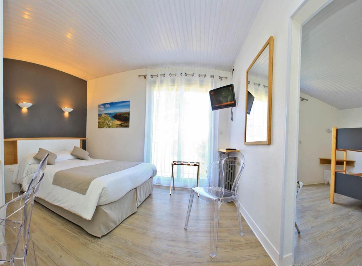Un ou plusieurs lits dans un hébergement de l'établissement Hotel Les Dunes