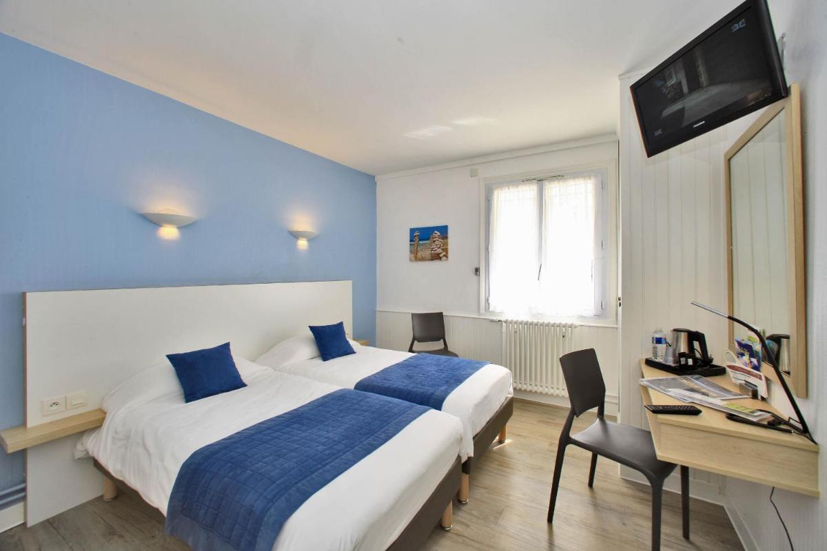 Un ou plusieurs lits dans un hébergement de l'établissement Hotel Les Dunes