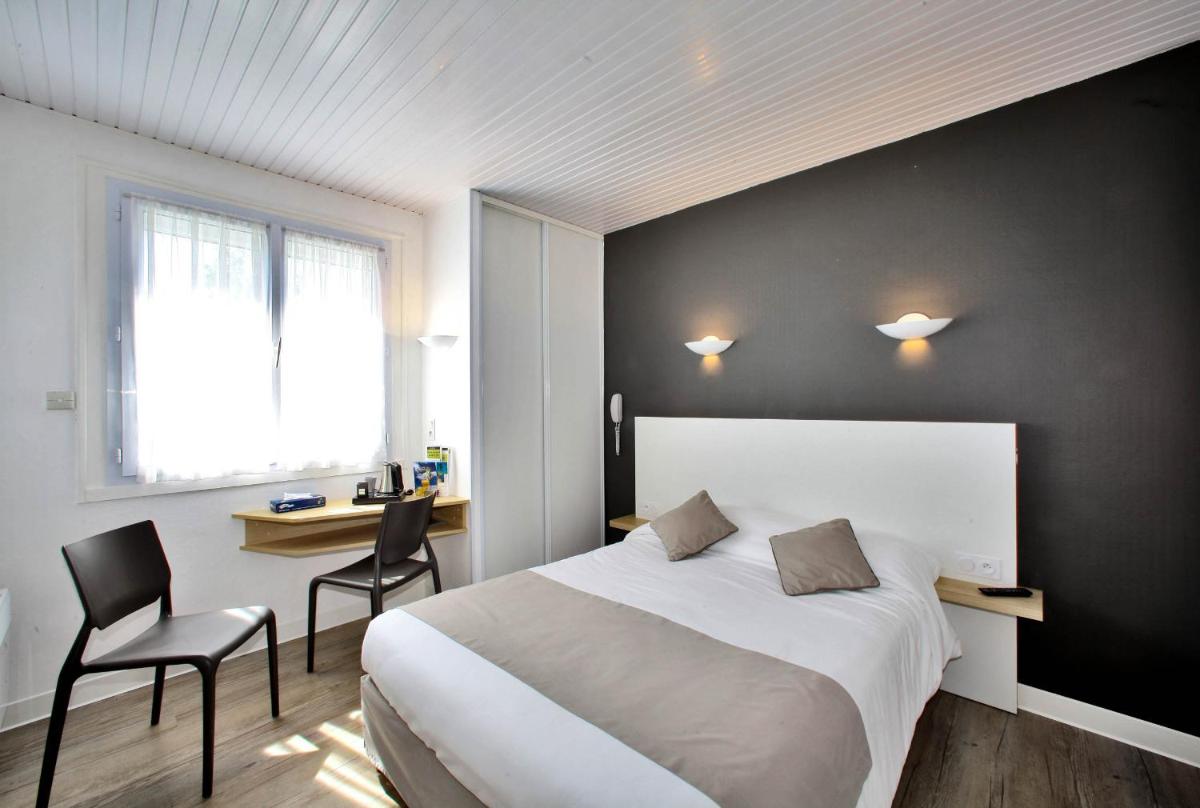 Un ou plusieurs lits dans un hébergement de l'établissement Hotel Les Dunes