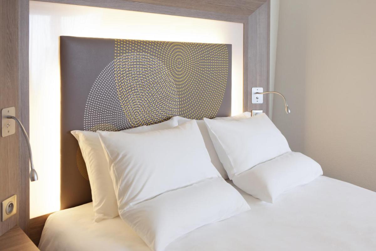 Un ou plusieurs lits dans un hébergement de l'établissement Novotel Senart Golf De Greenparc