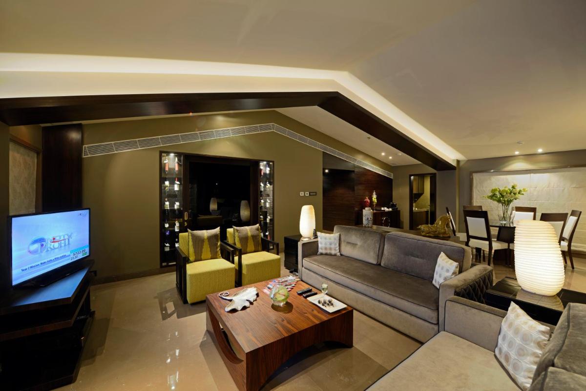 a living room with a couch and a television at Sun-n-Sand Mumbai Juhu Beach in Mumbai