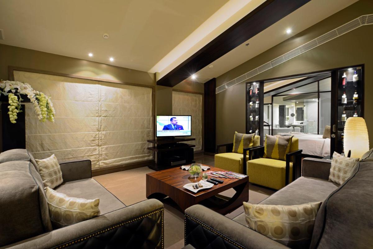 a living room with a couch and a television at Sun-n-Sand Mumbai Juhu Beach in Mumbai