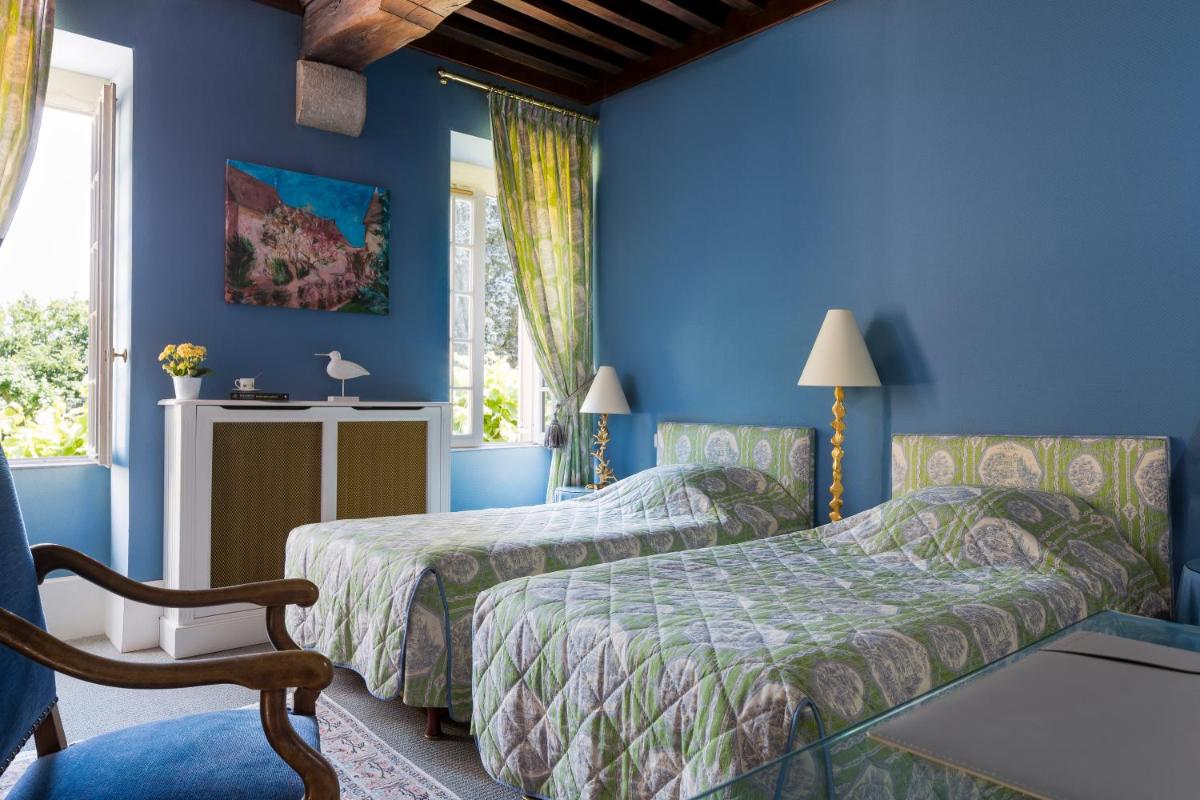 Un ou plusieurs lits dans un hébergement de l'établissement Château de Fleurville & Spa