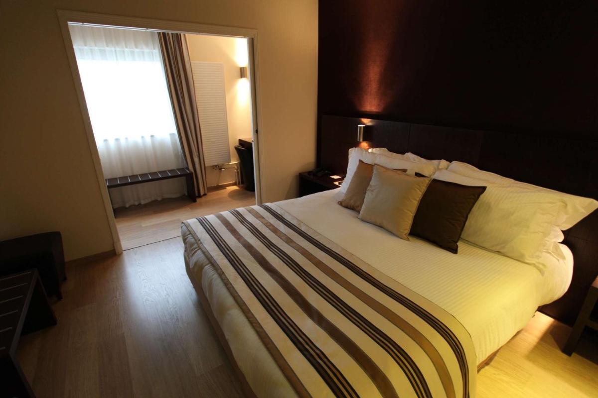 Un ou plusieurs lits dans un hébergement de l'établissement Best Western Plus Hotel des Francs