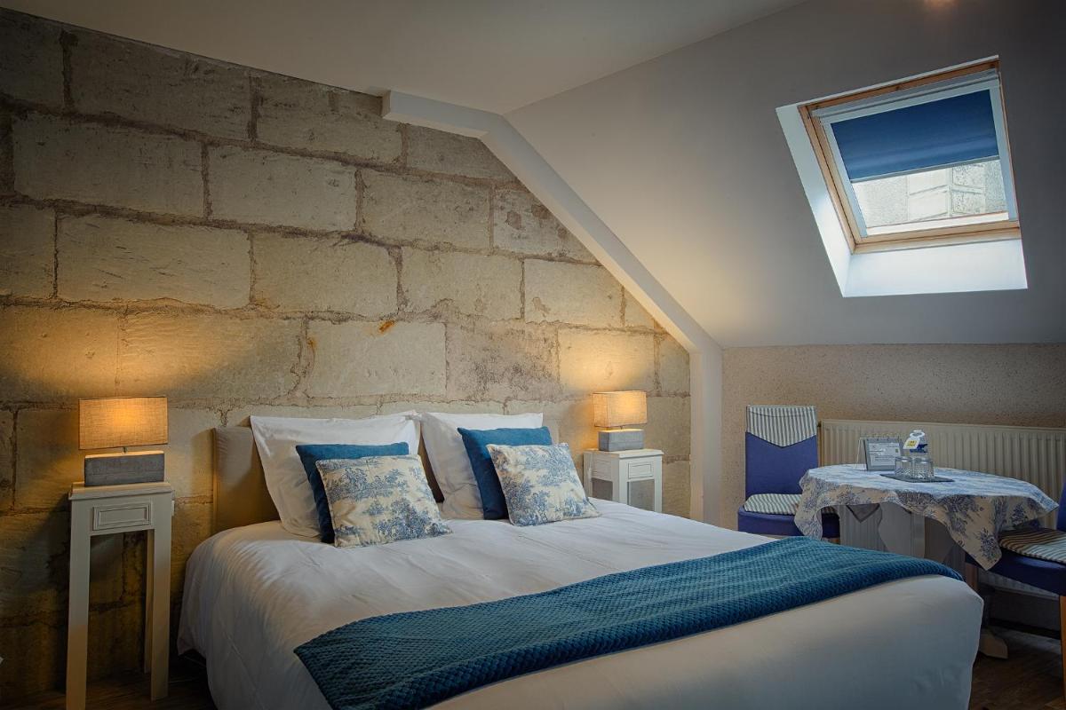 Un ou plusieurs lits dans un hébergement de l'établissement Hôtel & Spa Chai De La Paleine