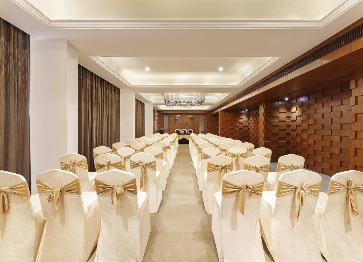 a room with a row of chairs in a room at La Marvella, Bengaluru in Bengaluru +25 photos