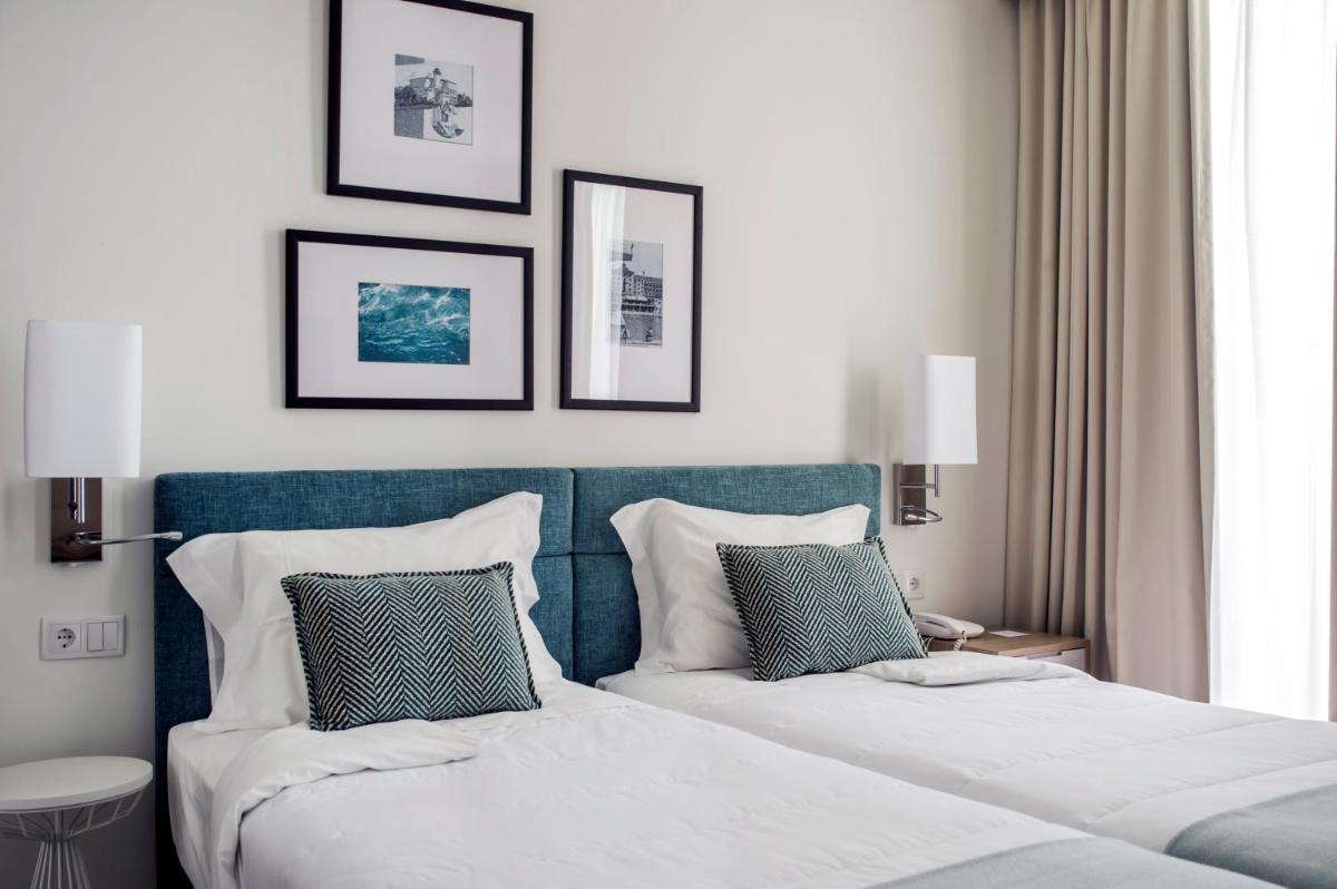 Uma cama ou camas num quarto em Grande Hotel De Luso