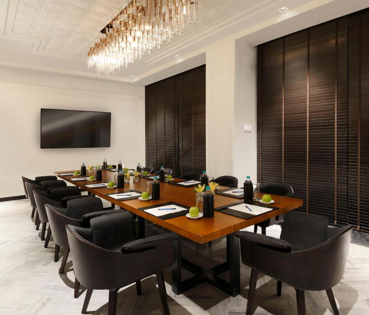 a large conference room with a long table and chairs at Novotel Chennai Chamiers Road in Chennai