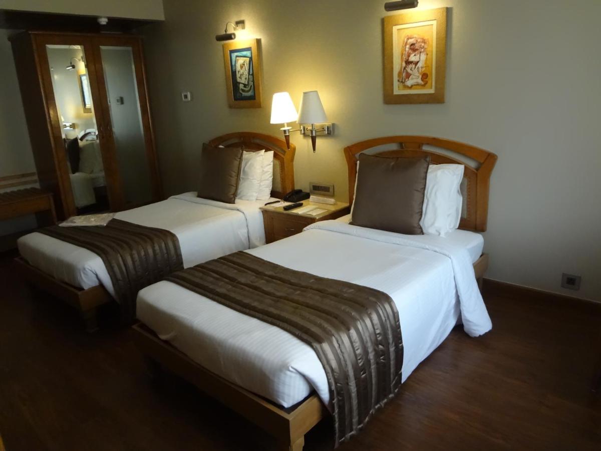a hotel room with two beds in a room at Sun-n-Sand Mumbai Juhu Beach in Mumbai