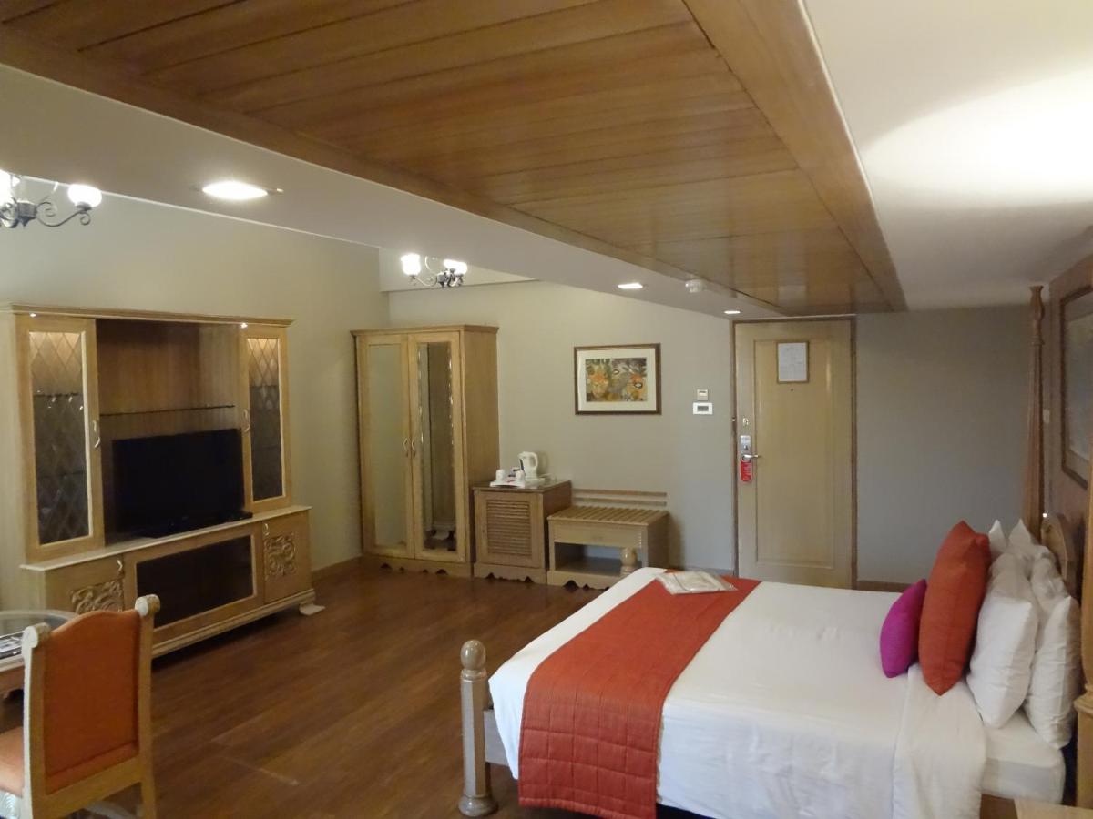 a bedroom with a large bed and a television at Sun-n-Sand Mumbai Juhu Beach in Mumbai