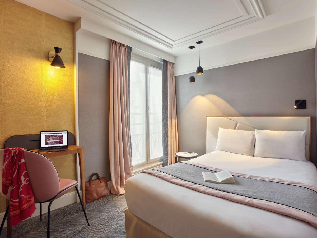 Un ou plusieurs lits dans un hébergement de l'établissement Mercure Paris Opera Garnier Hôtel & Spa