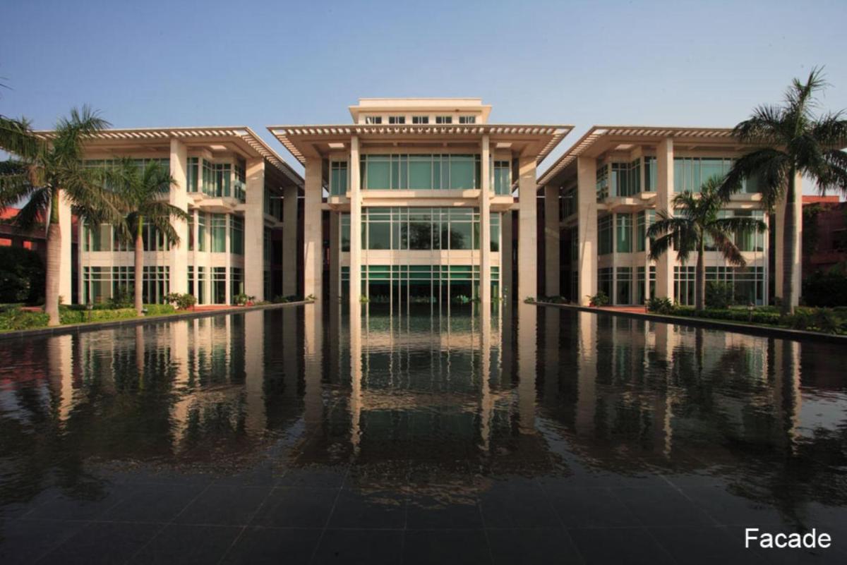 a building with a pool of water in front of it at Jaypee Palace Hotel in Agra