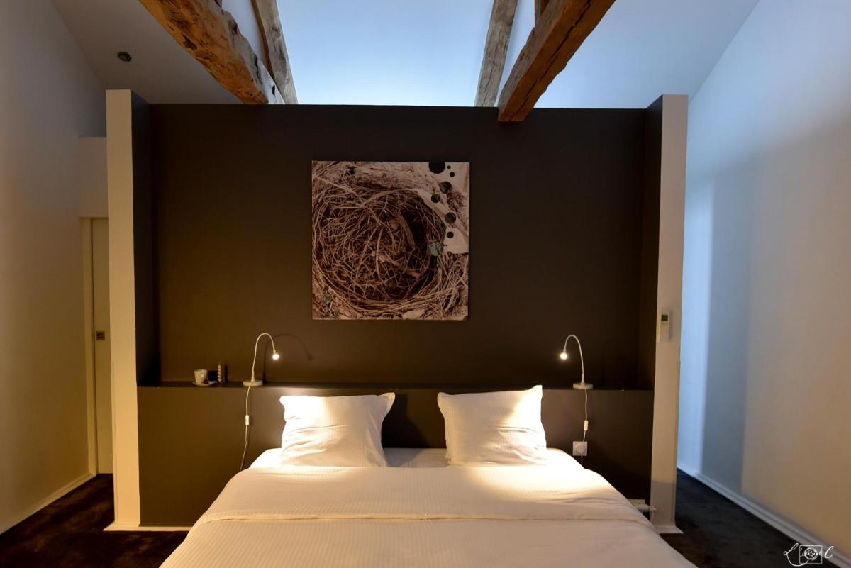 Un ou plusieurs lits dans un hébergement de l'établissement Le Domaine de Baulieu, Singuliers Hotels