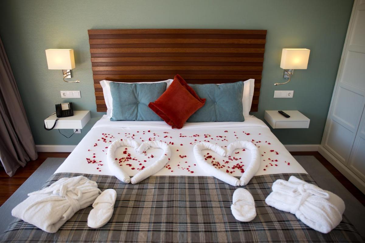Uma cama ou camas num quarto em Hotel São Bento da Porta Aberta & Spa