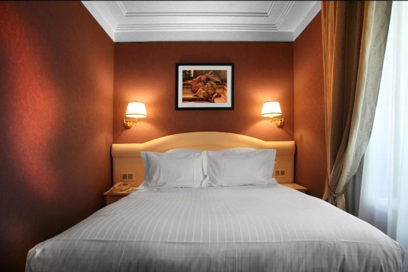 Un ou plusieurs lits dans un hébergement de l'établissement Hôtel Princesse Flore