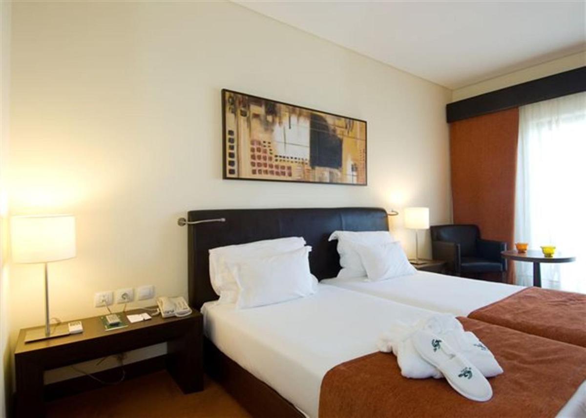 Uma cama ou camas num quarto em Vila Gale Santa Cruz