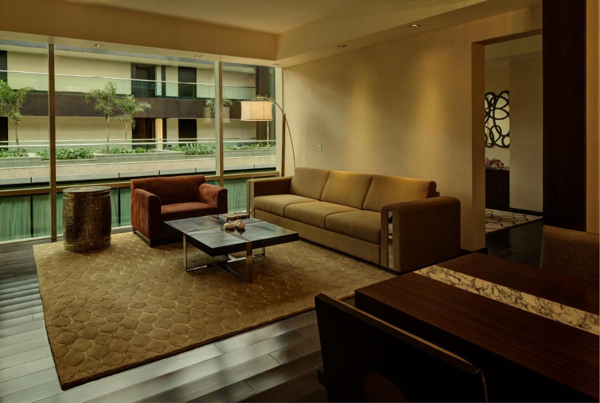 a living room with a couch and a table at Park Hyatt Hotel and Residences, Hyderabad in Hyderabad