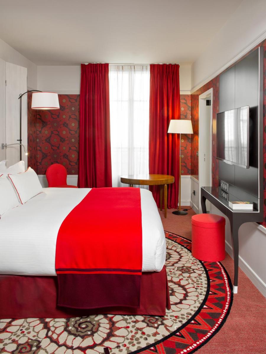 Un ou plusieurs lits dans un hébergement de l'établissement Carlton Hotel Lyon - MGallery Collection