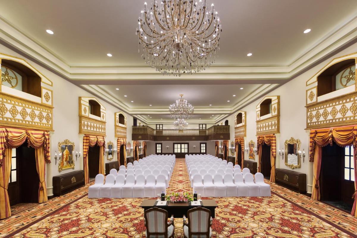 a banquet hall with white chairs and a chandelier at Welcomhotel by ITC Hotels, The Savoy, Mussoorie in Mussoorie